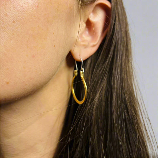 Brass Hoop suspended from silver ear wire on woman