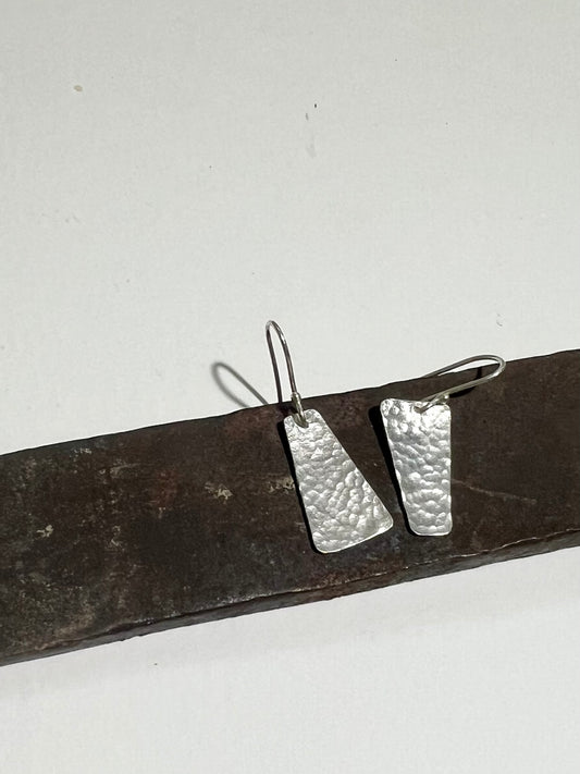 Pair of hammered silver trapezoids, asymmetrical. 