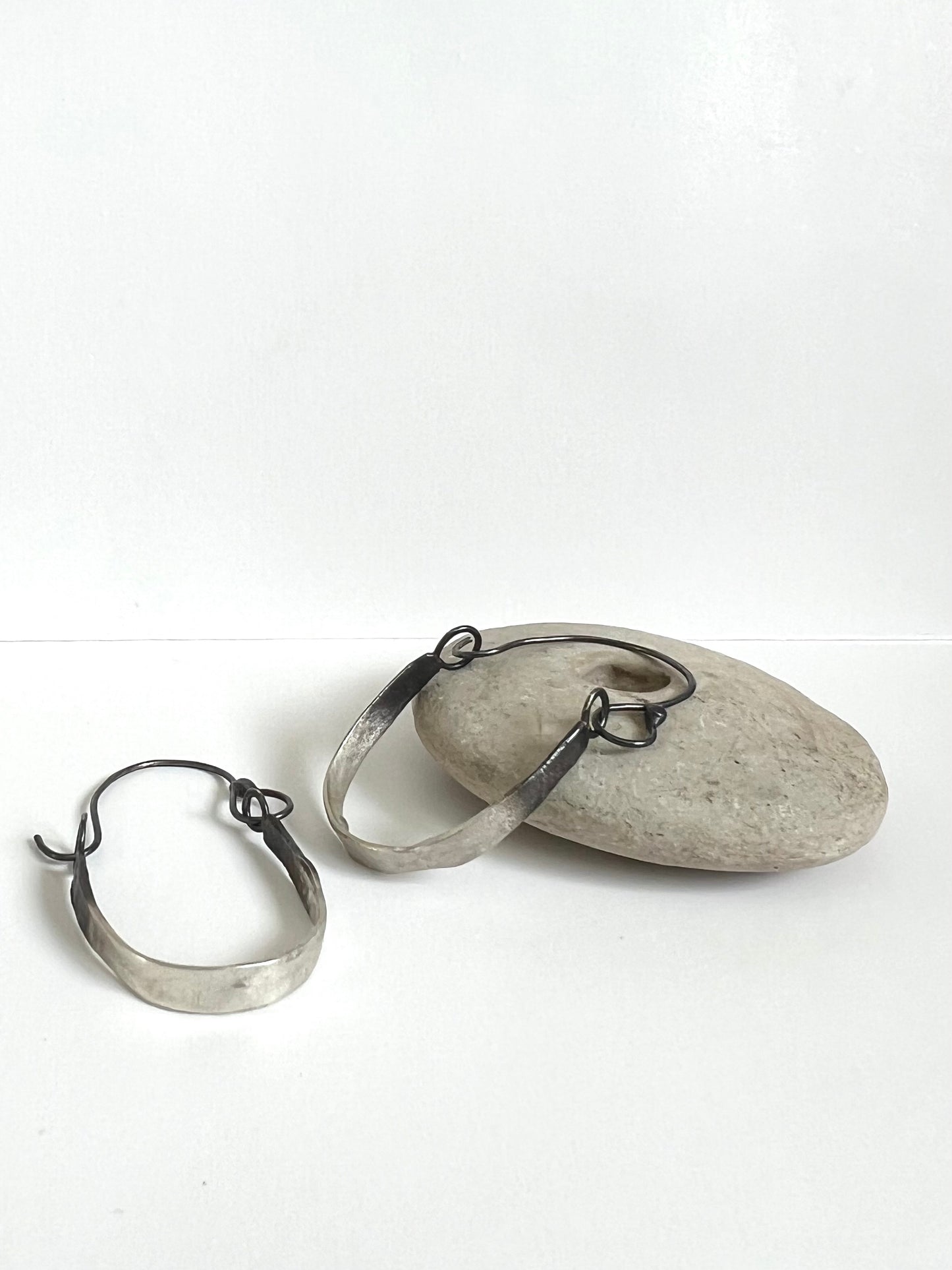 Handmade Silver Fused Hoops with oxidized detailing in Studio lighting.